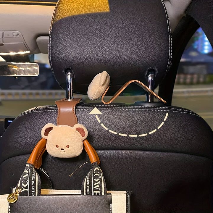 Dekorativer und funktionaler Auto-Haken mit Bär für die Rückbank, sichert Gegenstände während der Fahrt.