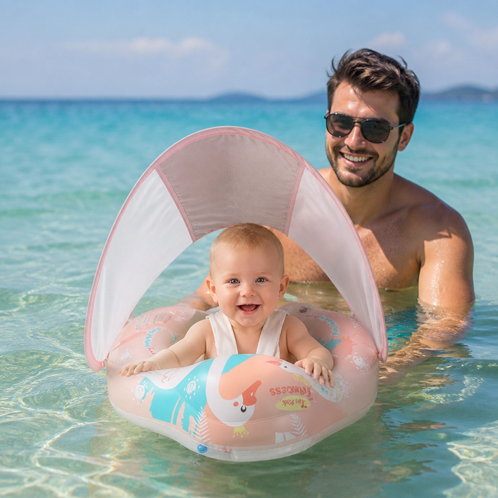 Glückliches Baby im Schwan Schwimmring mit Sonnenschutz. Sicherer Badespaß im Planschbecken oder am See.