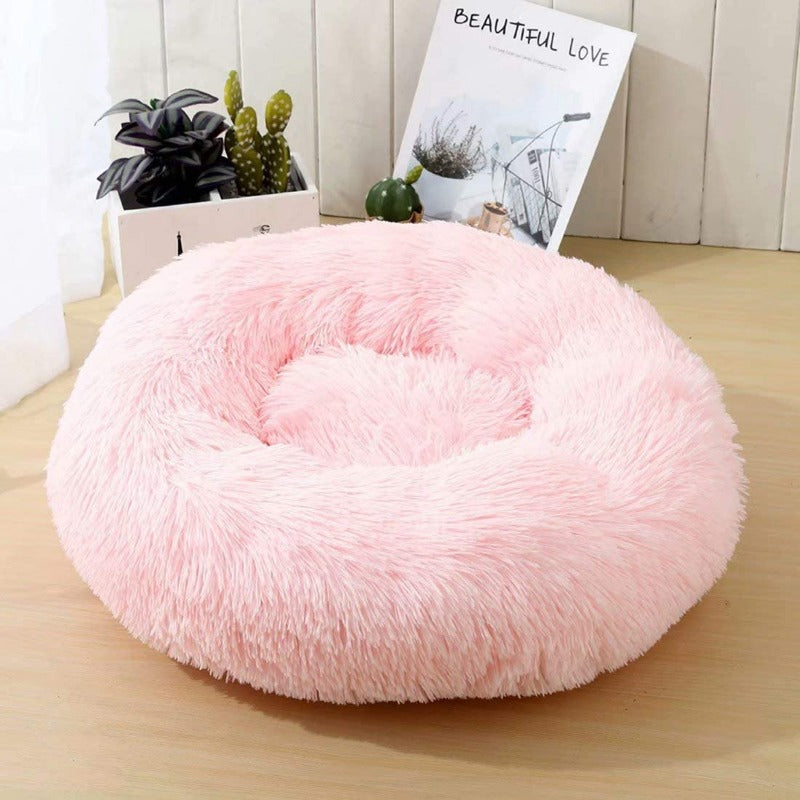Beruhigendes Donut Hundebett aus Plüsch, mit erhöhten Rändern für Kopfstütze.