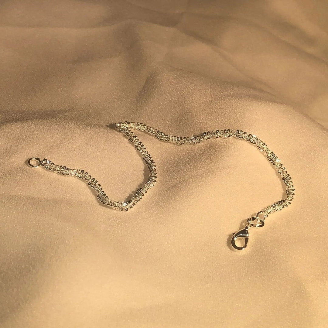 Nahaufnahme eines Damen Armbands aus poliertem Sterlingsilber, minimalistischer und eleganter Silberschmuck.