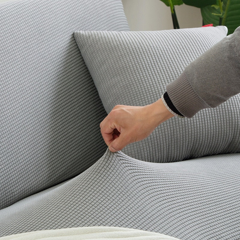Stretch-Sofahusse in Schwarz, passgenau und pflegeleicht, idealer Schutz für Ihr Möbelstück.