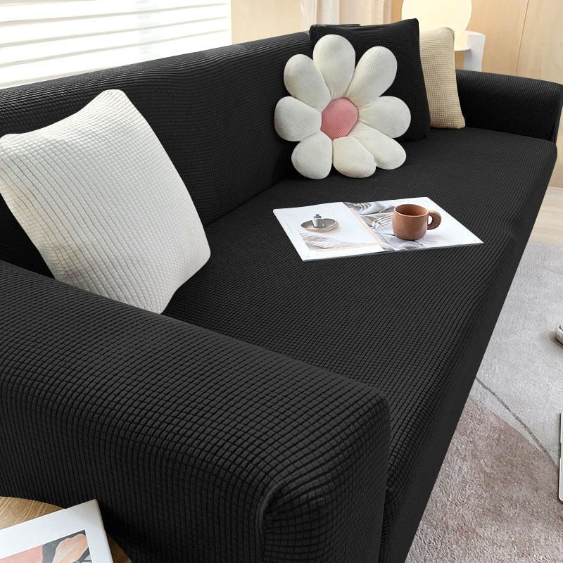 Stilvolle Sofahusse, dehnbar und strapazierfähig, ideal für eine schnelle Wohnzimmer-Veränderung.