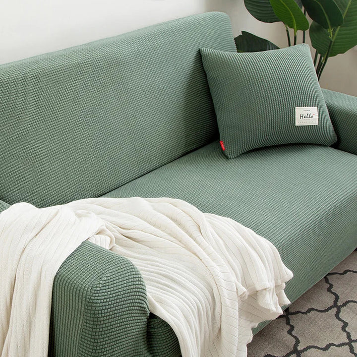Elastischer Jacquard Sofaüberwurf für 3-Sitzer in Grau, schützt das Sofa stilvoll im Wohnzimmer.