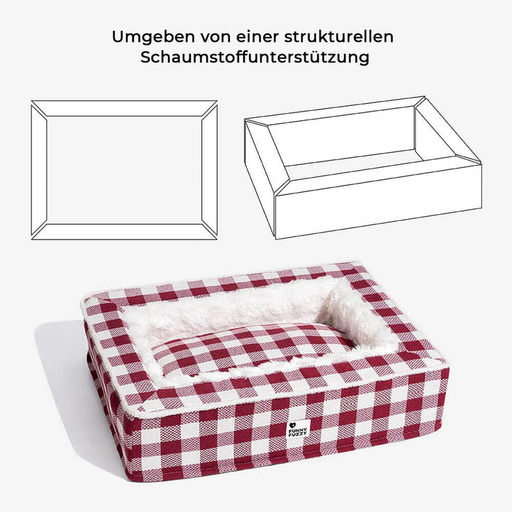 Ein glücklicher Hund schläft tief im orthopädischen Schottenmuster-Hundebett, umgeben von Plüsch.