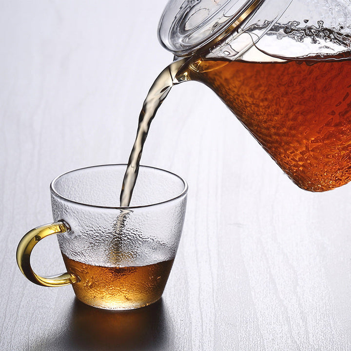 Teekanne mit goldfarbenem Griff und Sieb aus Borosilikatglas; luxuriöses Teewärmer-Accessoire.
