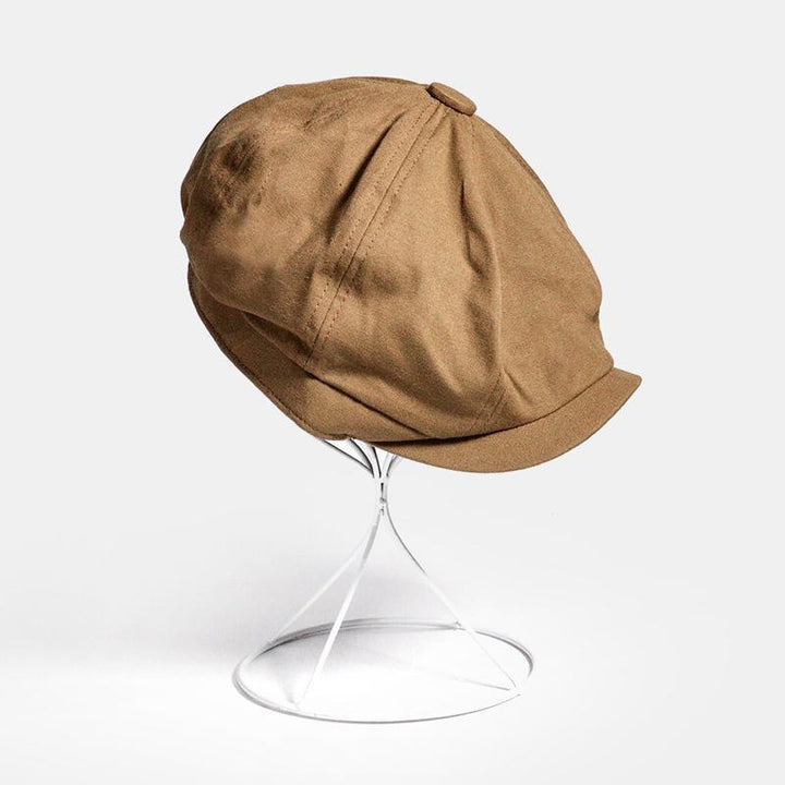 Mann trägt eleganten Vintage Herren Zeitungsjungenhut. Stilvolle Schirmmütze, perfektes Accessoire für Herrenmode.