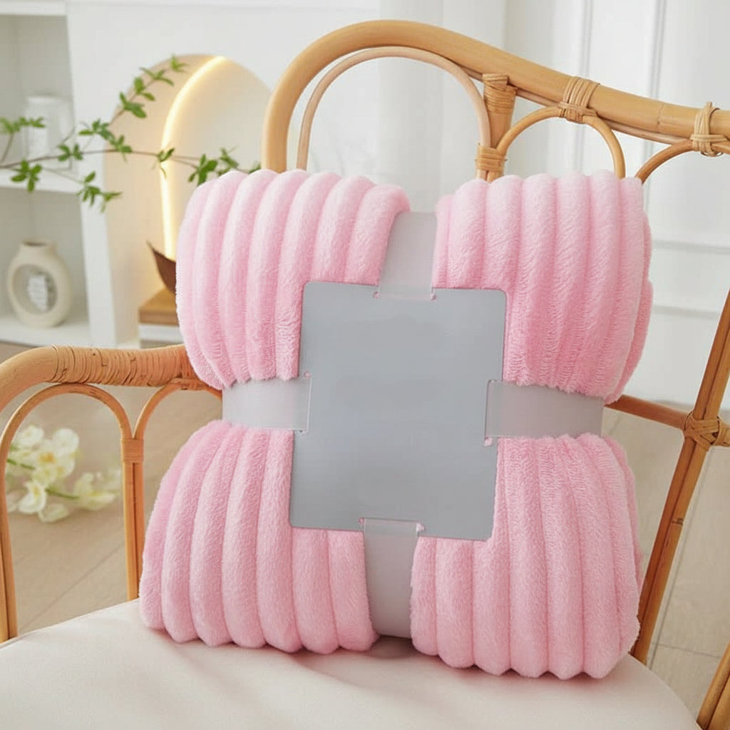 Gestreifte Flanell-Fleece-Kuscheldecke drapiert auf einem Bett, für einladende Wärme und ein stilvolles Ambiente.