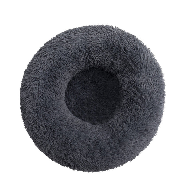 Schwarzes, komfortables Donut Hundebett aus Plüsch. Fördert Tiefschlaf und lindert Angst bei Haustieren.