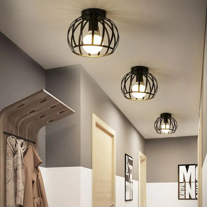 Trendige industrielle Deckenleuchte ForgeLight in Schwarz. Offenes Metall-Design schafft moderne Akzente für Innenbeleuchtung.