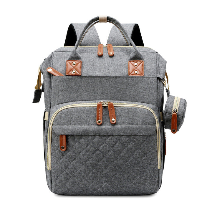 Der multifunktionale Babyrucksack von der Seite zeigt seine kompakte Form und das erweiterbare Wickelbett.