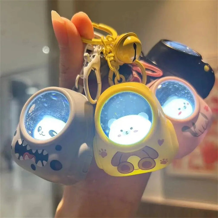 Grauer Katzen-Astronaut Schlüsselanhänger mit gelbem Helm und hellem LED-Licht. Ein praktischer Alltagshelfer.
