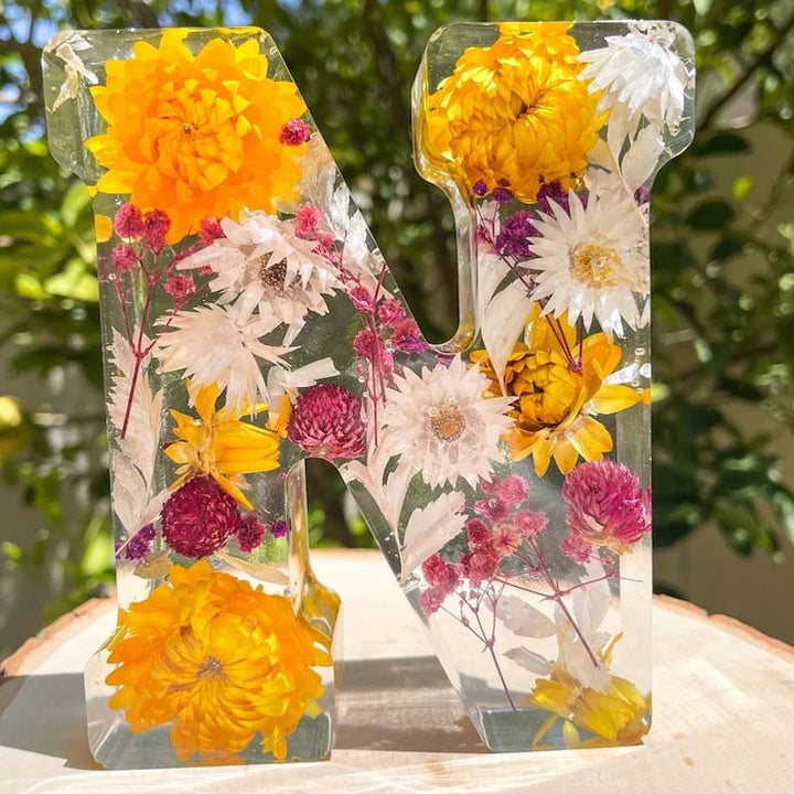 Dekoratives LED-Nachtlicht in Buchstabenform mit Harzblumen, ideal für individuelle Wohnakzente.