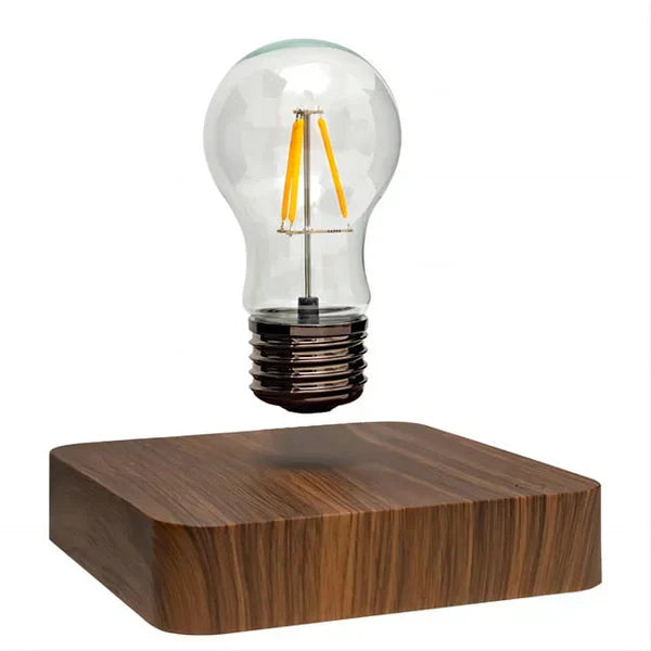 Magische Levitation LED Lampe: schwebende Glühbirne erzeugt warmes Ambiente Licht auf edlem Walnussholz-Sockel.