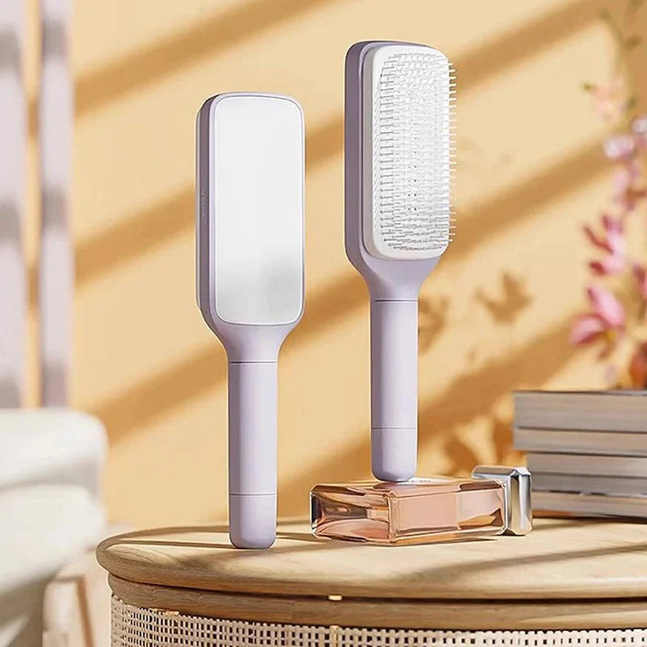 Lila Air-Cushion Entwirrbürste für sanfte Kopfhautmassage und einfache Haarpflege.