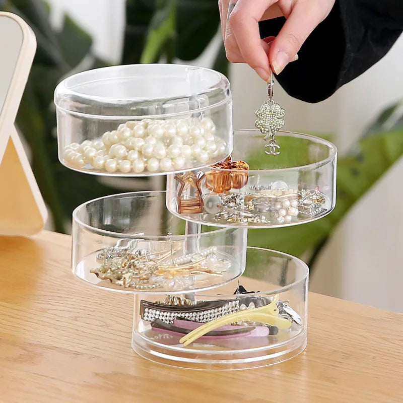 Offener transparenter Schmuck-Organizer mit verschiedenen Fächern, der 360° drehbar ist und Kosmetik fasst.