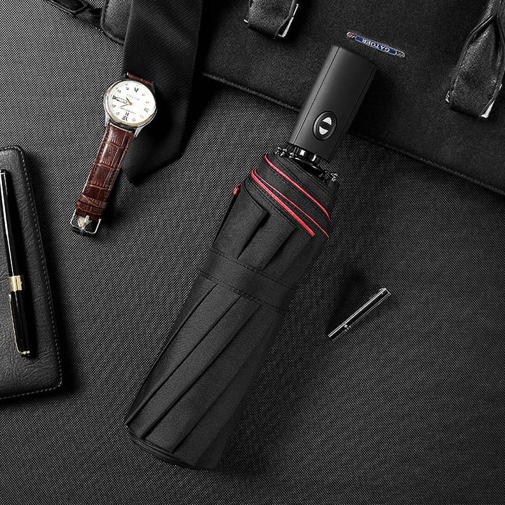 Detailaufnahme: Automatischer Öffnungsmechanismus des robusten unisex Sturmschirms, winddicht & kompakt.