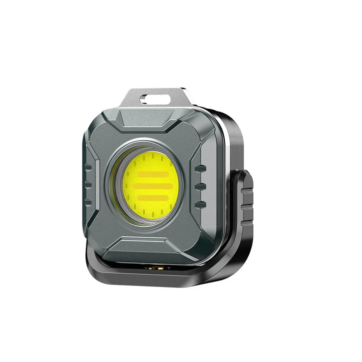 Kompakte, wiederaufladbare LED-Arbeitsleuchte in Hand. Magnetisch, dimmbar, für unterwegs & Notfälle.